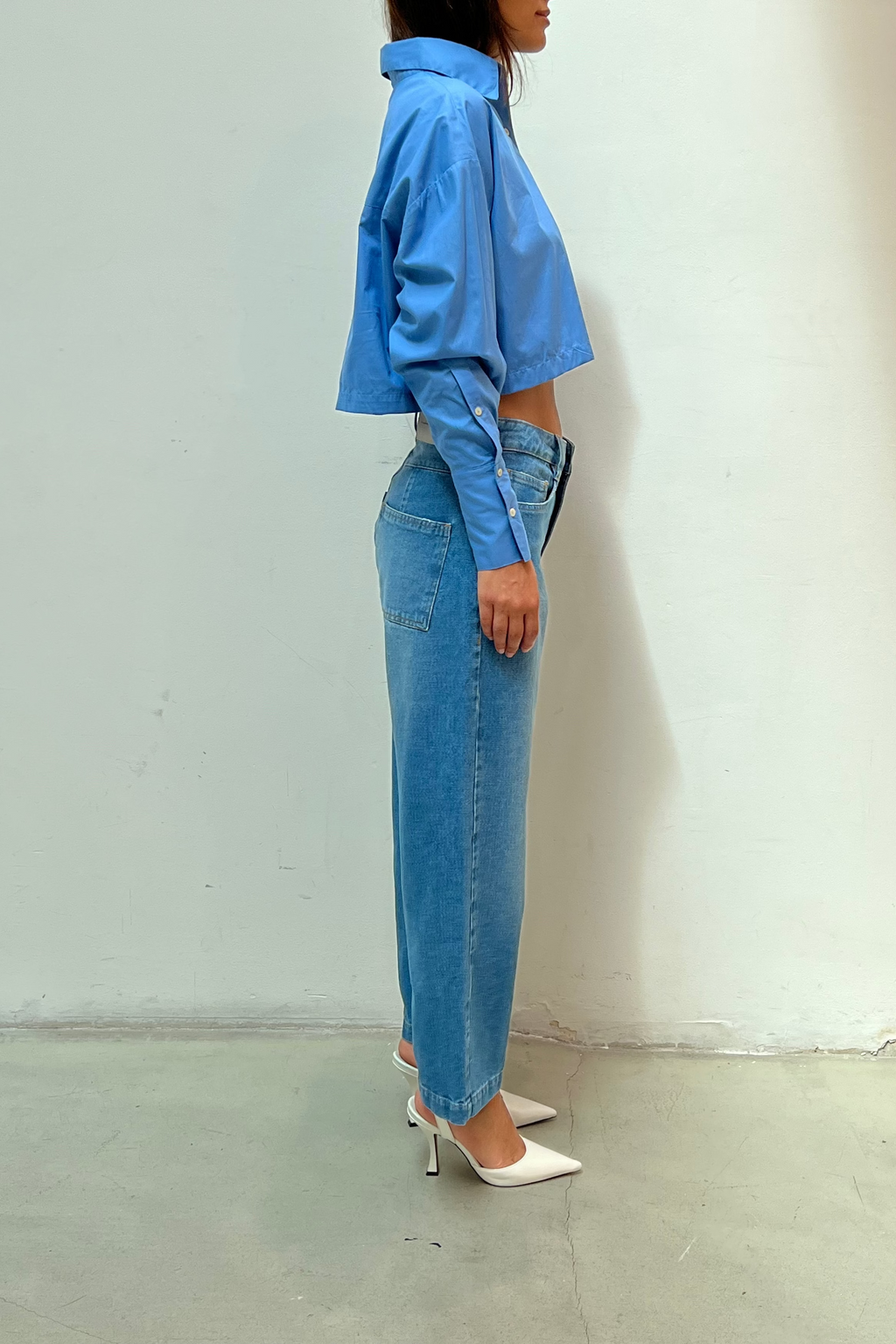 Modelo usando Calça Jeans Reta Cropped Karoline Vitto, vista lateral